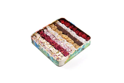 Open metal tin with several rows of differently styled Turkish Delight pieces