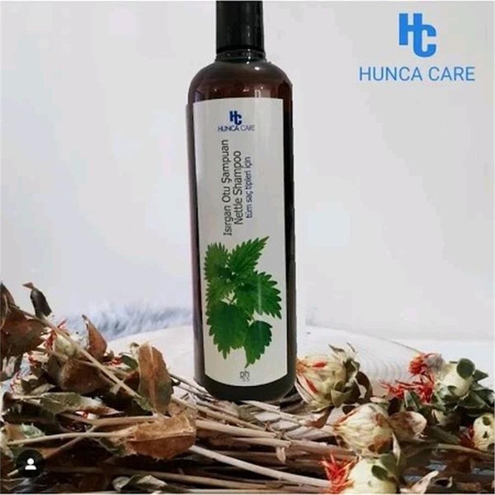 Dark brown bottle of Hunca Care Nettle Shampoo 675 ml with green nettle leaf design