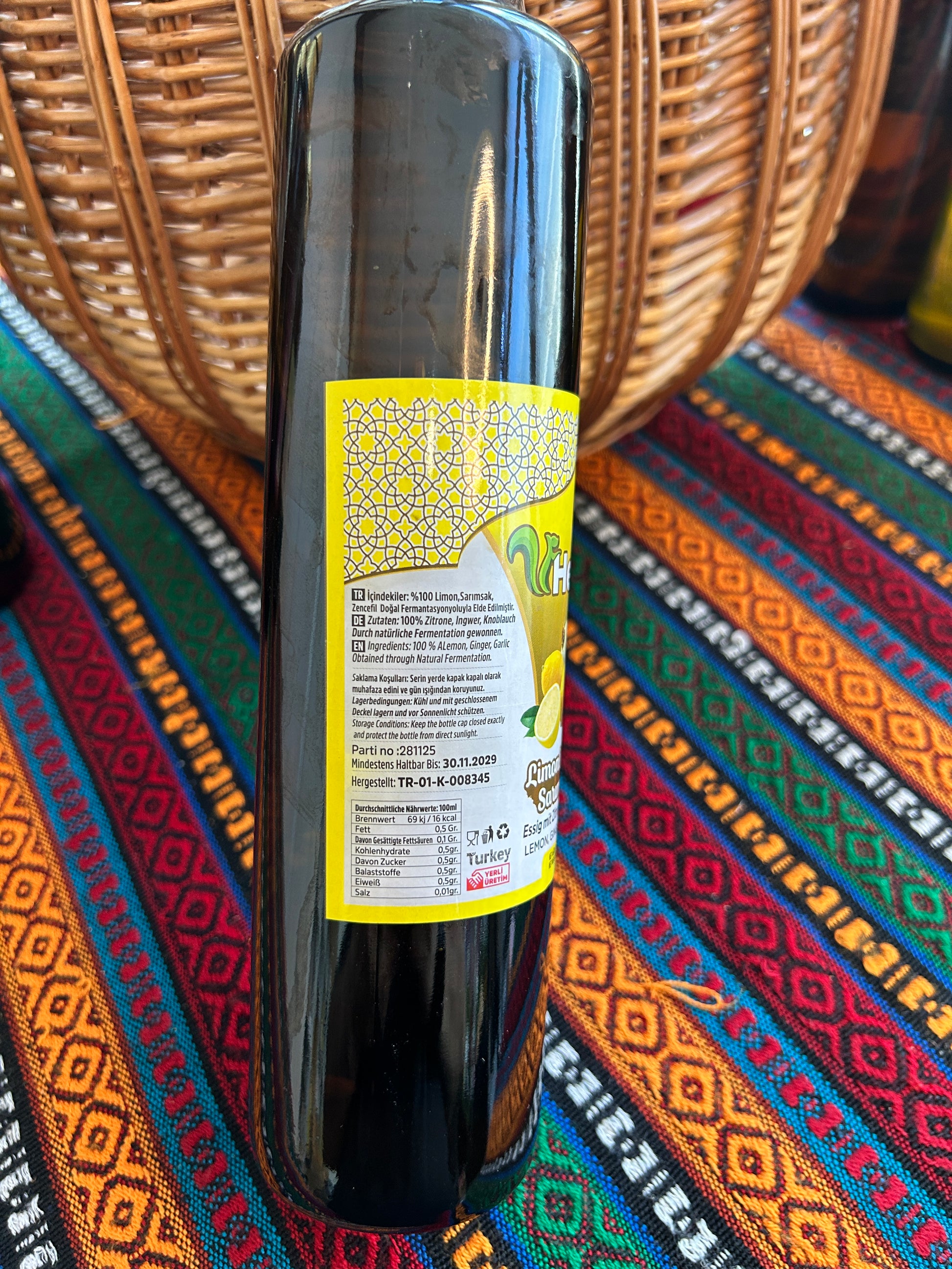 Close-up of vinegar bottle showing ingredients, nutritional values and yellow label