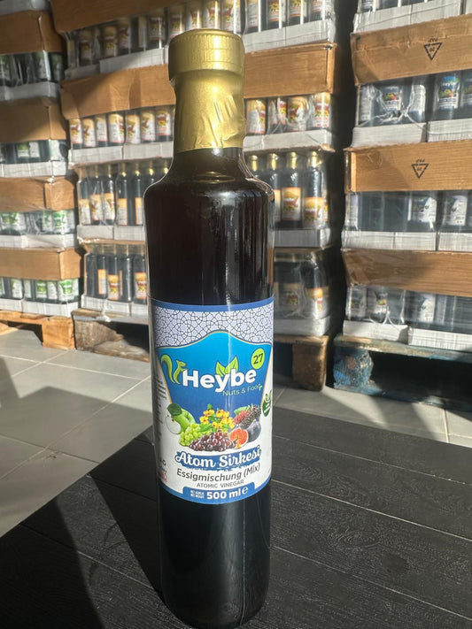 Atom Vinegar Mix 500 ml in a dark bottle with blue fruit label