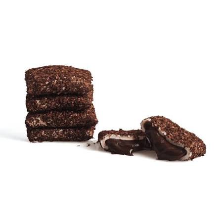 Rectangular Turkish Delight pieces with a coconut-coated surface and visible dark interior on a white background