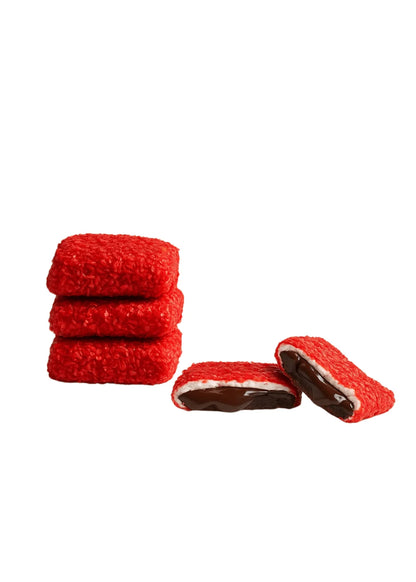 Red Muska Turkish Delight pieces with two cut open to show a light layer and dark filling