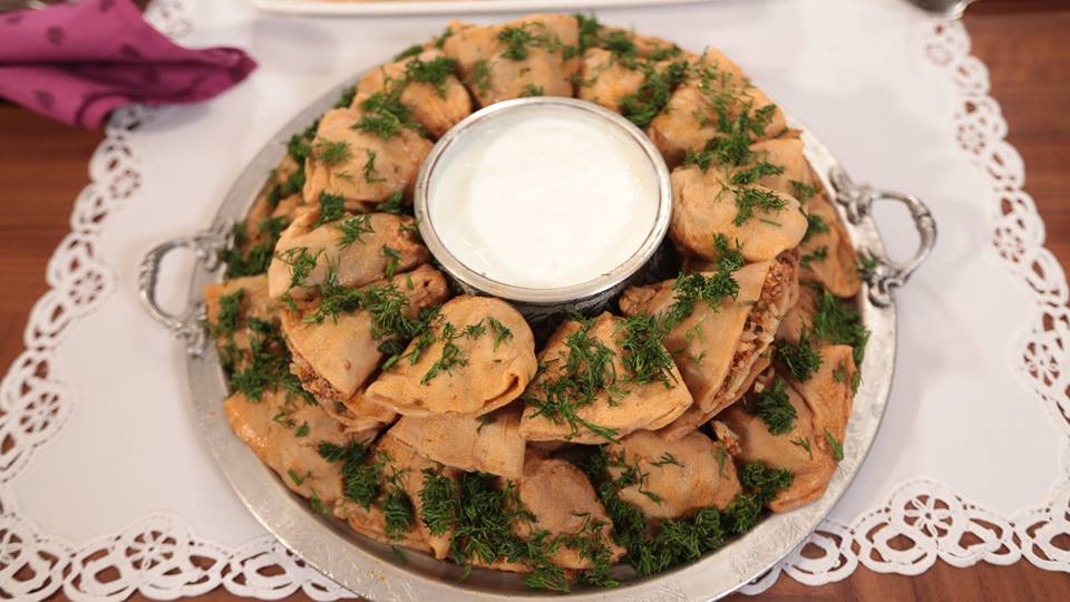 Hollow dried zucchini filled with rice and served with yogurt